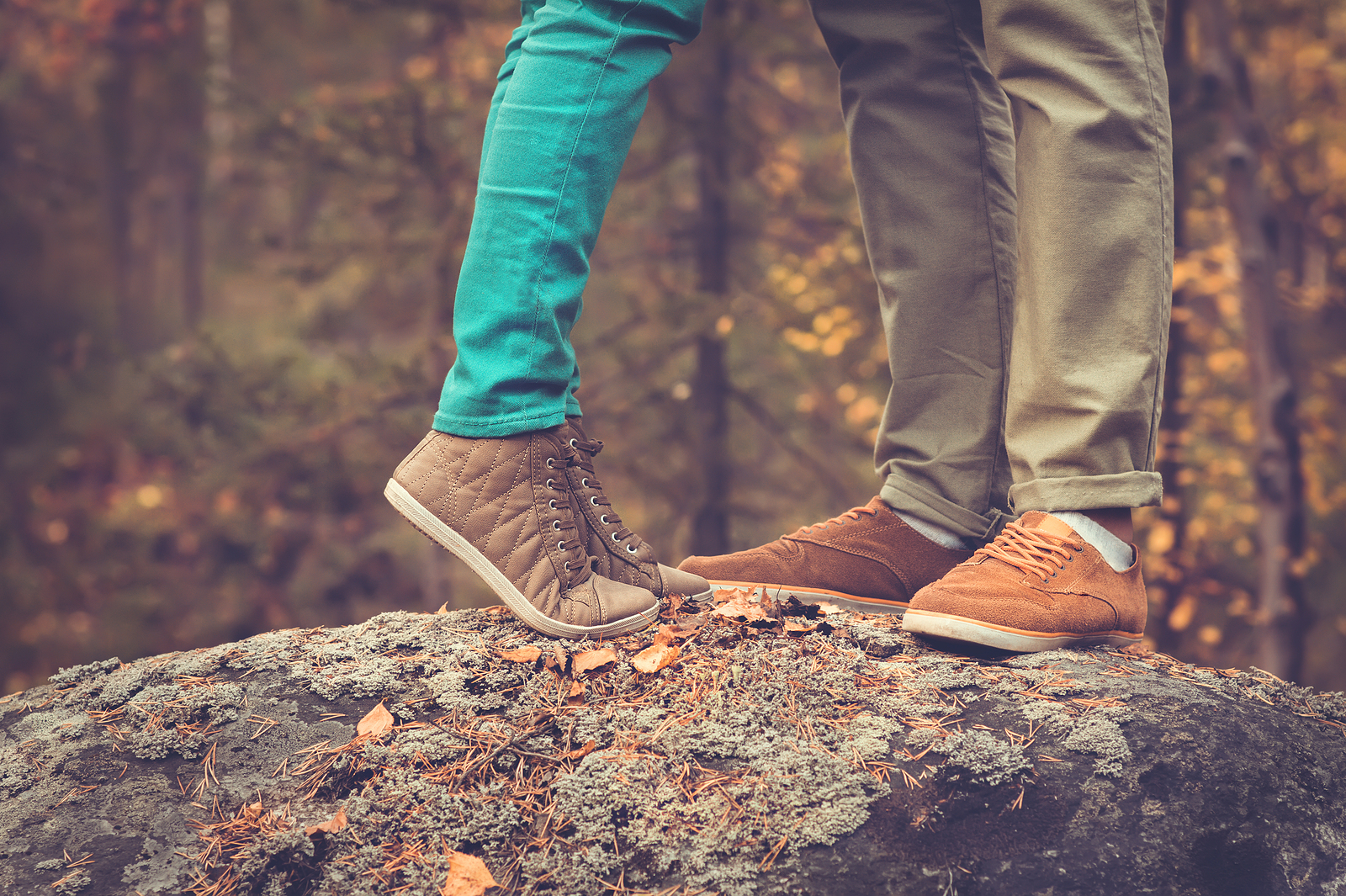 Couple woman and man standing together on a rock